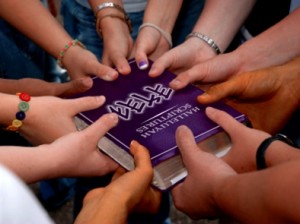 Prayer with hands over the Scriptures